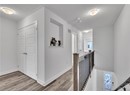 Hallway with light hardwood / wood-style flooring and a textured ceiling