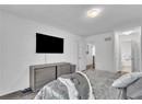 Bedroom featuring ensuite bathroom and hardwood / wood-style floors