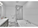 Full bathroom with vanity, toilet, and separate shower and tub