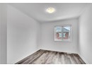 Unfurnished room featuring wood-type flooring and a textured ceiling