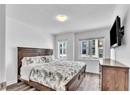 Bedroom with light hardwood / wood-style flooring and a textured ceiling