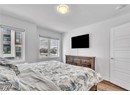 Bedroom featuring a textured ceiling and light hardwood / wood-style floors