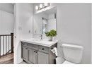 Bathroom featuring vanity, toilet, and wood-type flooring
