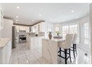 Kitchen featuring recessed lighting, stainless steel appliances, a center island, tasteful backsplash, and white cabinetry