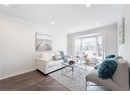Living room with baseboards, crown molding, dark wood-type flooring, and recessed lighting