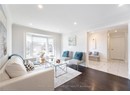 Living area featuring baseboards, wood finished floors, recessed lighting, and ornamental molding