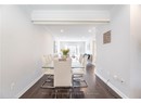 Dining space featuring baseboards, crown molding, dark wood-type flooring, and recessed lighting