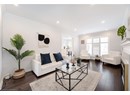 Living room with ornamental molding, dark wood-type flooring, and recessed lighting
