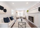Living area with crown molding, a fireplace, recessed lighting, and dark wood-style flooring