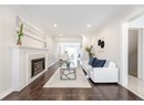 Living room with recessed lighting, a premium fireplace, wood finished floors, and ornamental molding