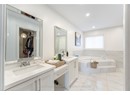Full bath featuring a bath, a walk in closet, vanity, marble finish floor, and recessed lighting