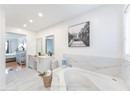 Full bath featuring a garden tub, connected bathroom, vanity, marble finish floor, and recessed lighting