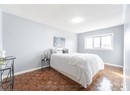 Bedroom featuring a textured ceiling and baseboards