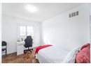 Bedroom featuring a textured ceiling, visible vents, and baseboards