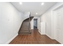 Stairway featuring baseboards, wood finished floors, and recessed lighting
