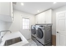 Washroom with a sink, visible vents, recessed lighting, separate washer and dryer, and cabinet space