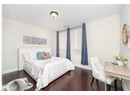 Bedroom featuring baseboards, visible vents, and wood finished floors
