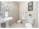 Bathroom featuring baseboards, toilet, and a bidet