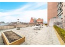 View of patio / terrace with a gazebo, fence, and a vegetable garden