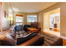Living area with a chandelier, wood finished floors, and a textured ceiling