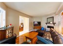 Living room featuring wood finished floors and a brick fireplace