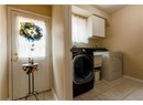 Washroom with cabinet space, light tile patterned floors, and separate washer and dryer