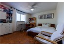 Bedroom with a textured ceiling and a ceiling fan