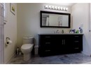 Full bathroom featuring vanity and marble finish flooring