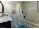 Bathroom featuring shower / bath combination with curtain and vanity