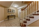 Entrance foyer with light tile patterned floors, a textured ceiling, and stairway