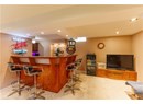 Indoor dry bar with carpet and recessed lighting