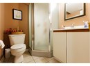 Bathroom featuring a stall shower, tile patterned floors, and vanity
