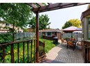 Fenced backyard featuring a pergola, an outdoor structure, outdoor dining space, and a patio