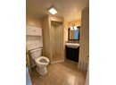 Bathroom featuring vanity, a stall shower, backsplash, and tile patterned floors