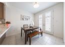 Dining room featuring light tile patterned floors and french doors