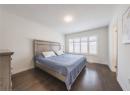 Bedroom with dark wood-style floors and a textured ceiling