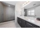 Full bath featuring vanity, a stall shower, and tile patterned flooring