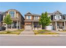 Craftsman-style home featuring concrete driveway, a garage, brick siding, and covered porch