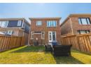 Back of property with brick siding, a fenced backyard, and an outdoor living space