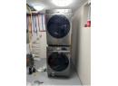 Washroom with stacked washer / drying machine and water heater