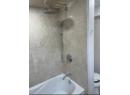 Bathroom view of toilet and tub / shower combination