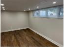Below grade area with recessed lighting and dark wood finished floors