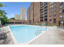 Community pool with a patio and a view of city