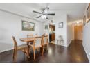 Dining room with dark wood-style flooring, a textured ceiling, and ceiling fan