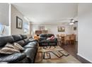 Living area with dark wood finished floors, a textured ceiling, and ceiling fan