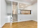 Stairway featuring wood finished floors, recessed lighting, crown molding, and a baseboard heating unit