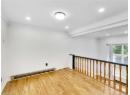 Unfurnished room featuring ornamental molding, baseboard heating, wood finished floors, and recessed lighting