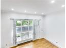 Unfurnished room featuring baseboard heating, light wood-type flooring, ornamental molding, and recessed lighting