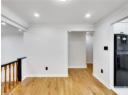 Empty room with light wood-style floors, crown molding, and recessed lighting