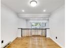 Unfurnished room featuring light wood finished floors, crown molding, recessed lighting, and a baseboard radiator